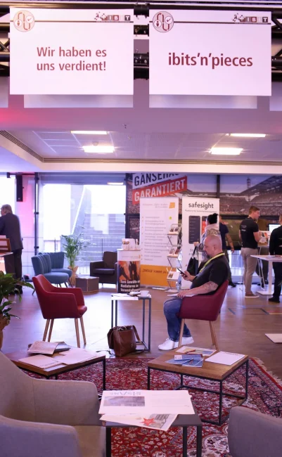 Moderne Veranstaltungsumgebung mit Teilnehmern, die sich austauschen. IBIT präsentiert Weiterbildung zu Veranstaltungssicherheit.